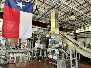 Packing hall in Alamo Beer Company, San Antonio, Texas. A Texas flag hangs in view.