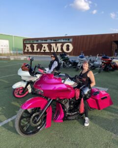 A biking club meets at Alamo Beer Company and poses for a picture in front of the iconic Alamo sign